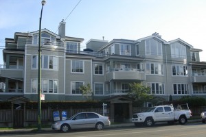 Condo apartment exterior in tan, white and grey