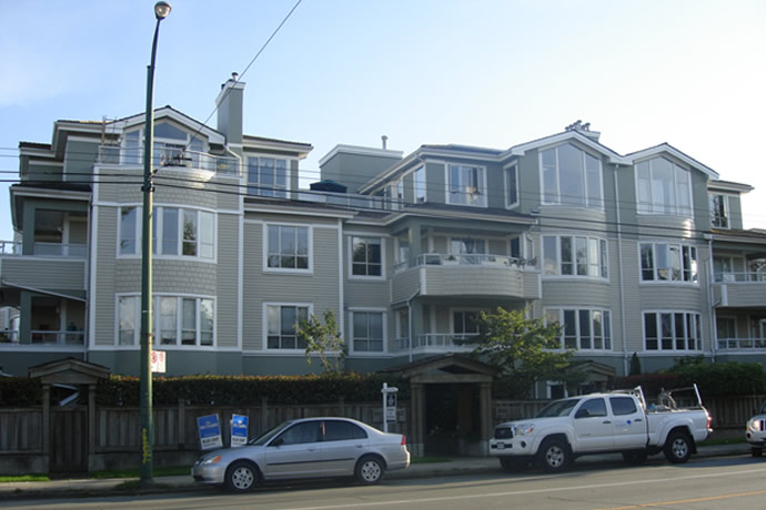 Condo apartment exterior in tan, white and grey