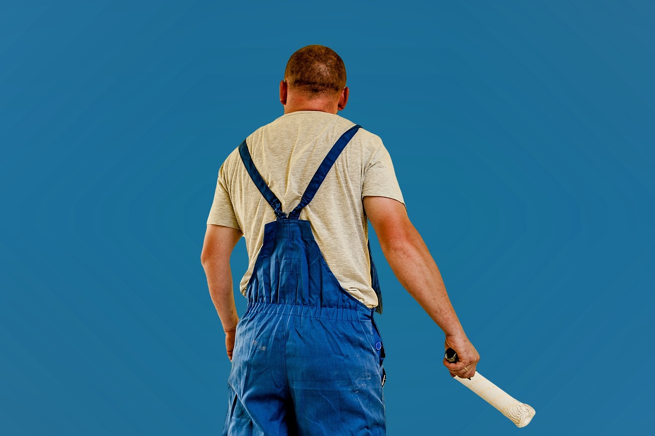 A professional painter working on a residential home's interior wall